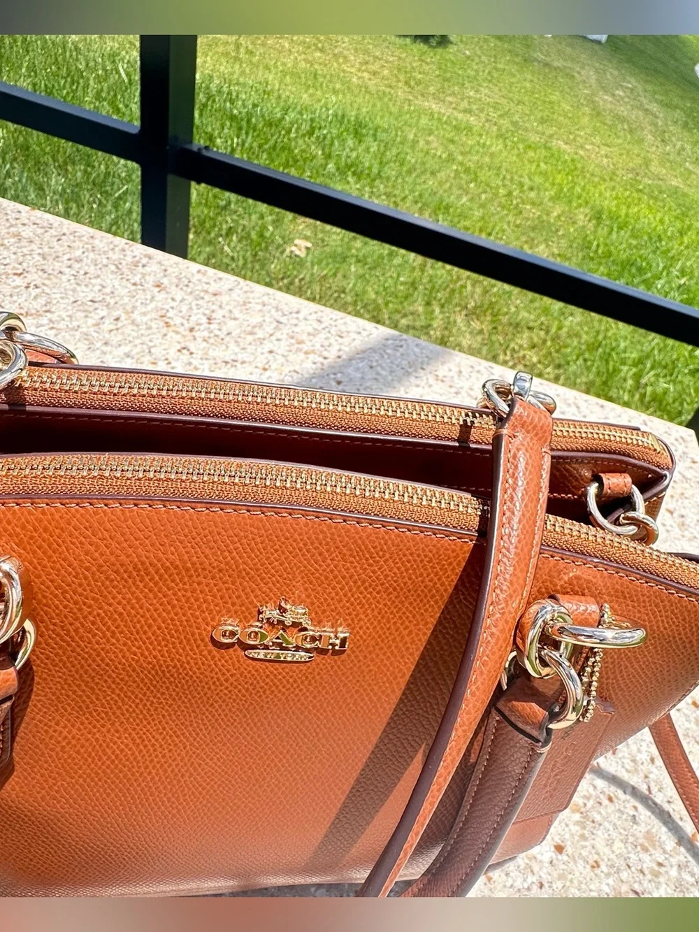 Coach Christie Carryall in a brown, textured leather with gold-tone hardware